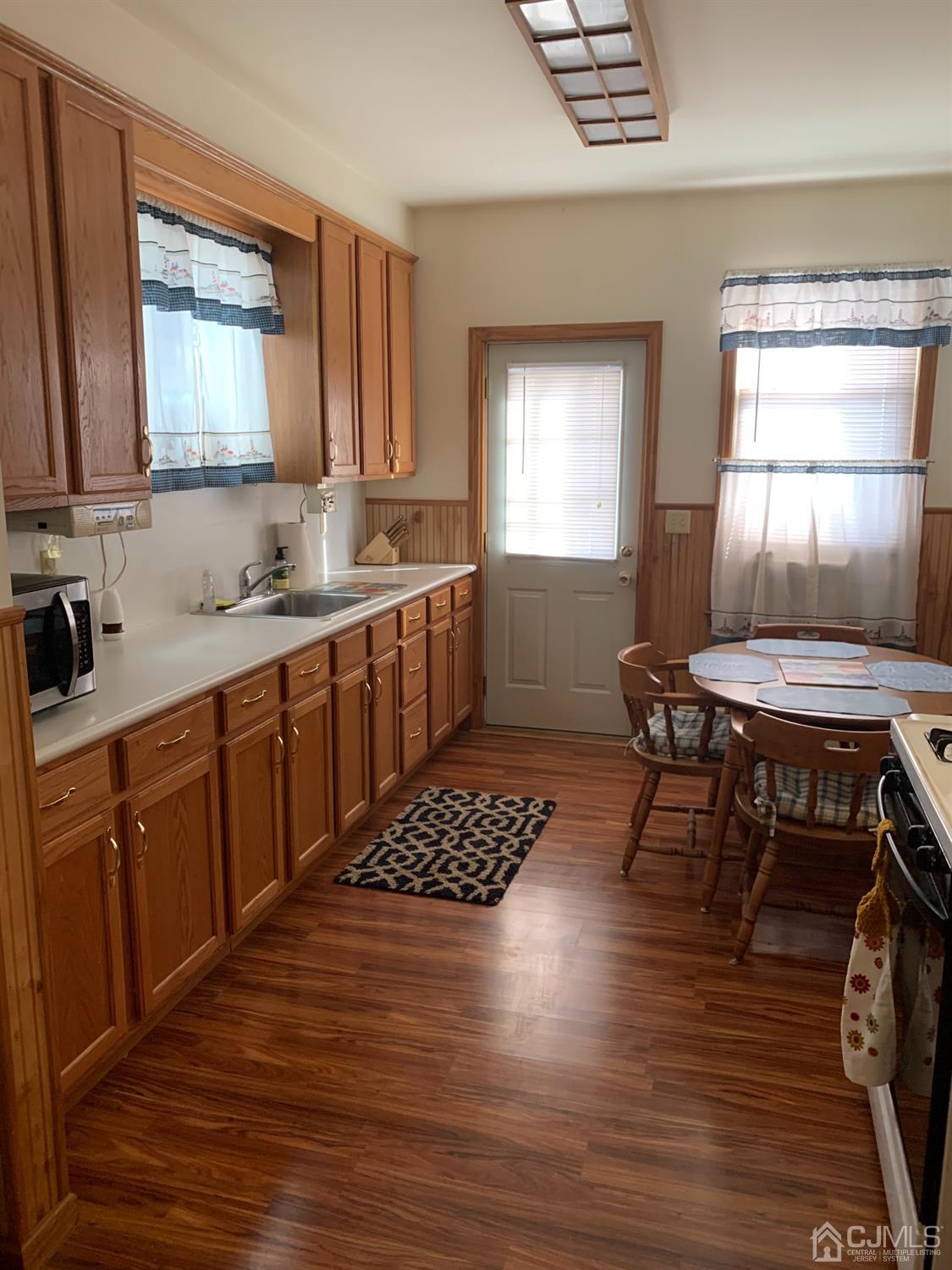 138 Rector Street Perth Amboy, NJ 08861 - Photo 6 of 15 a kitchen with a table chairs sink and cabinets
