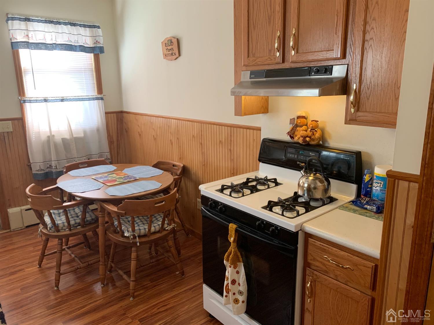 138 Rector Street Perth Amboy, NJ 08861 - Photo 7 of 15 a kitchen with a stove a table and chairs in it