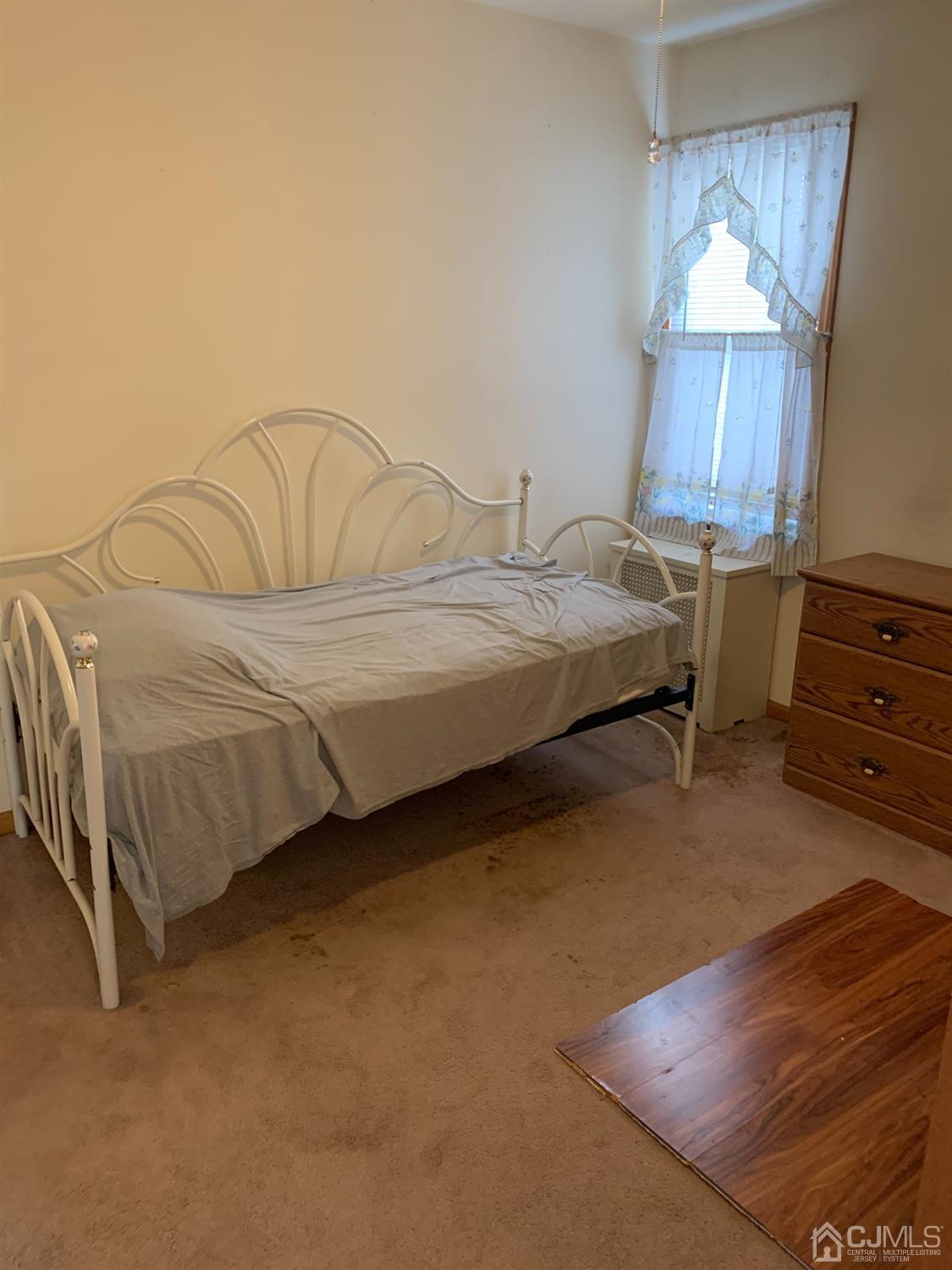 138 Rector Street Perth Amboy, NJ 08861 - Photo 10 of 15 a bedroom with a bed and a dresser