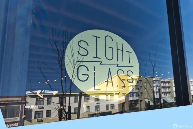 a front view of a residential apartment building with a yard