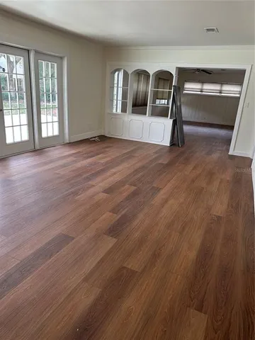 wooden floor in an empty room with a window