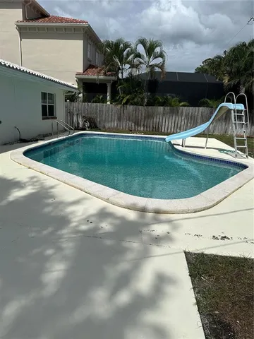 a view of a house with a backyard