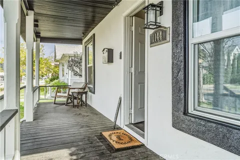 a view of a balcony with wooden floor and furniture