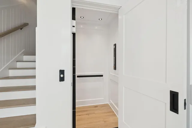 a living room with furniture a flat screen tv and a large window