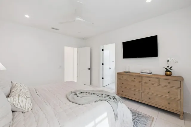 a spacious bedroom with a large bed and a large window