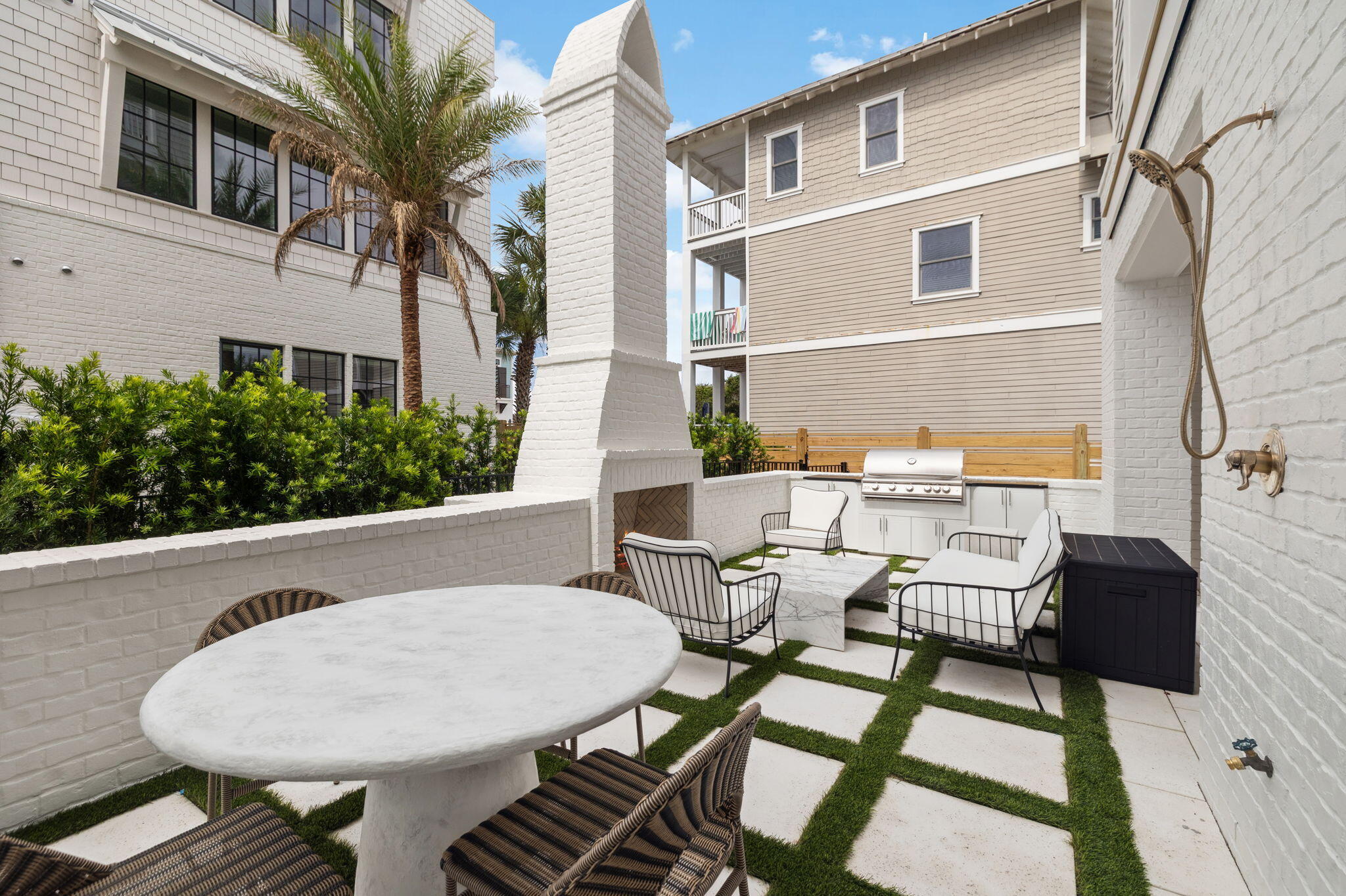 8978 East County Highway Inlet Beach, FL 32461 - Photo 29 of 116 a view of a patio with table and chairs with wooden floor and fence