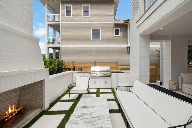 a view of a hallway with wooden floor a glass door and a bathroom