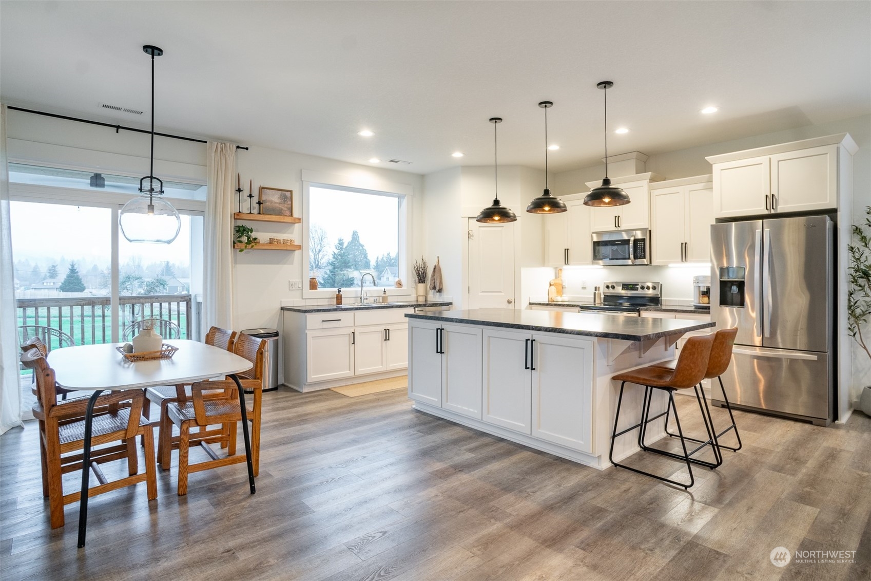 703 D Street Vader, WA 98593 - Photo 12 of 39 a kitchen with a table chairs refrigerator and microwave