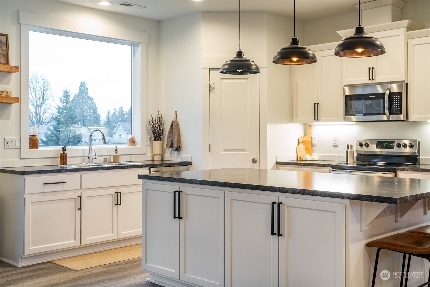 703 D Street Vader, WA 98593 - Photo 13 of 39 a kitchen with stainless steel appliances a sink a stove and a wooden floor