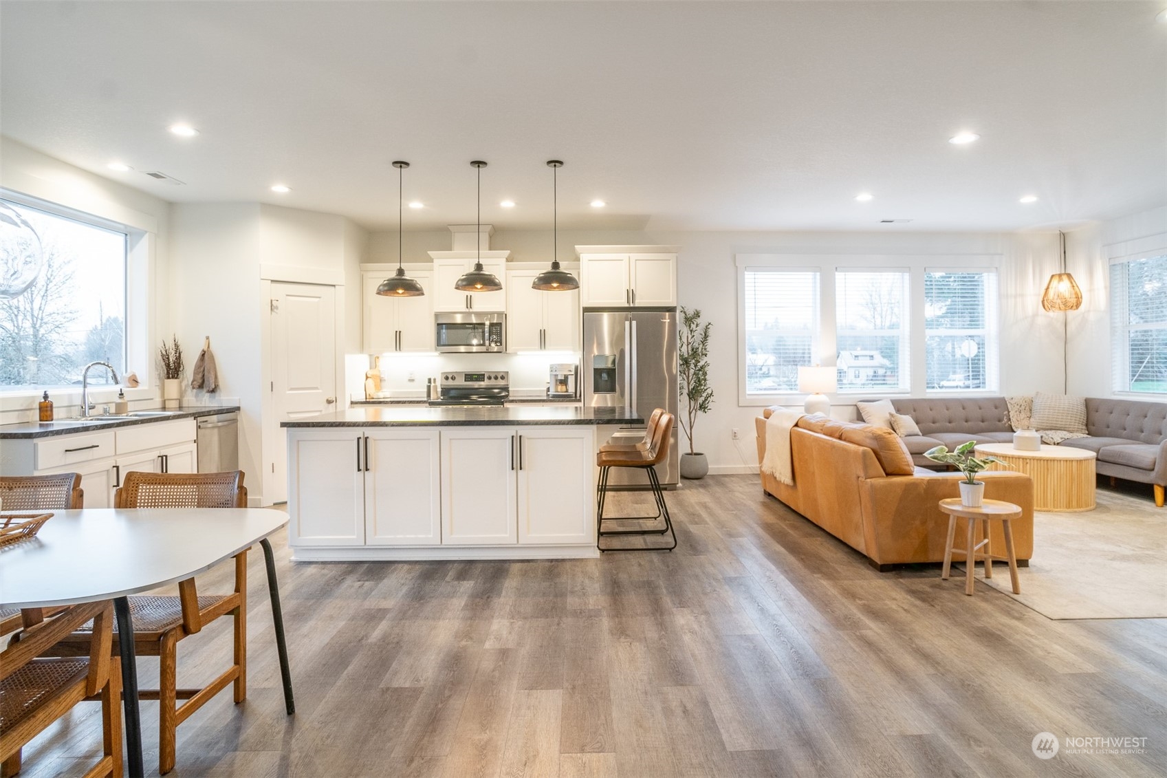 703 D Street Vader, WA 98593 - Photo 16 of 39 a large white kitchen with a large window and stainless steel appliances