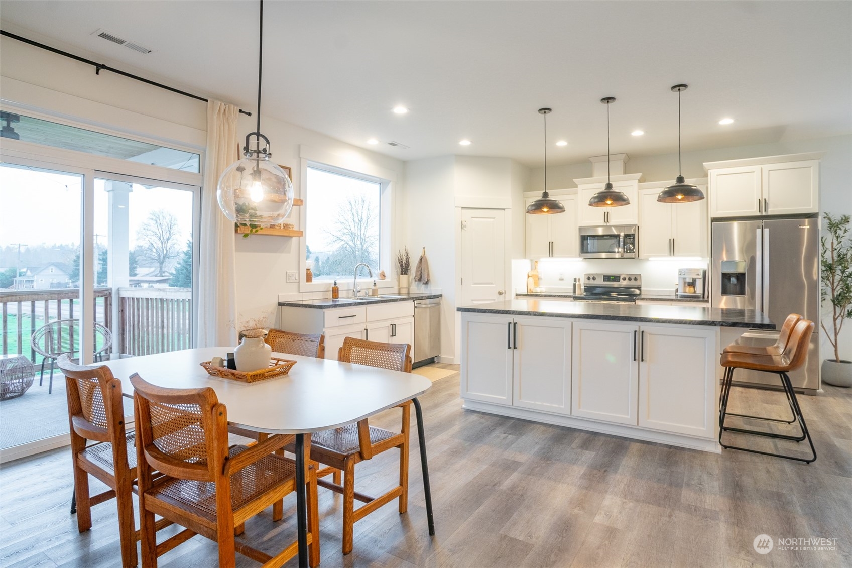 703 D Street Vader, WA 98593 - Photo 17 of 39 a kitchen with a dining table chairs wooden floor appliances and cabinets