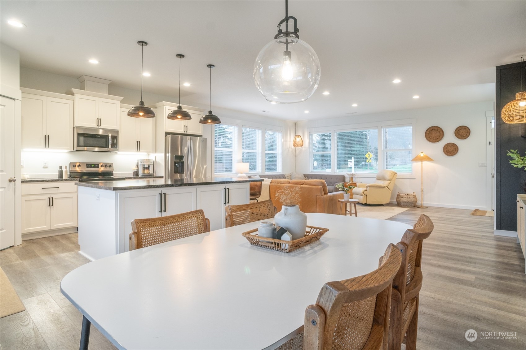 703 D Street Vader, WA 98593 - Photo 18 of 39 a dining room with kitchen island stainless steel appliances furniture wooden floor and a kitchen view