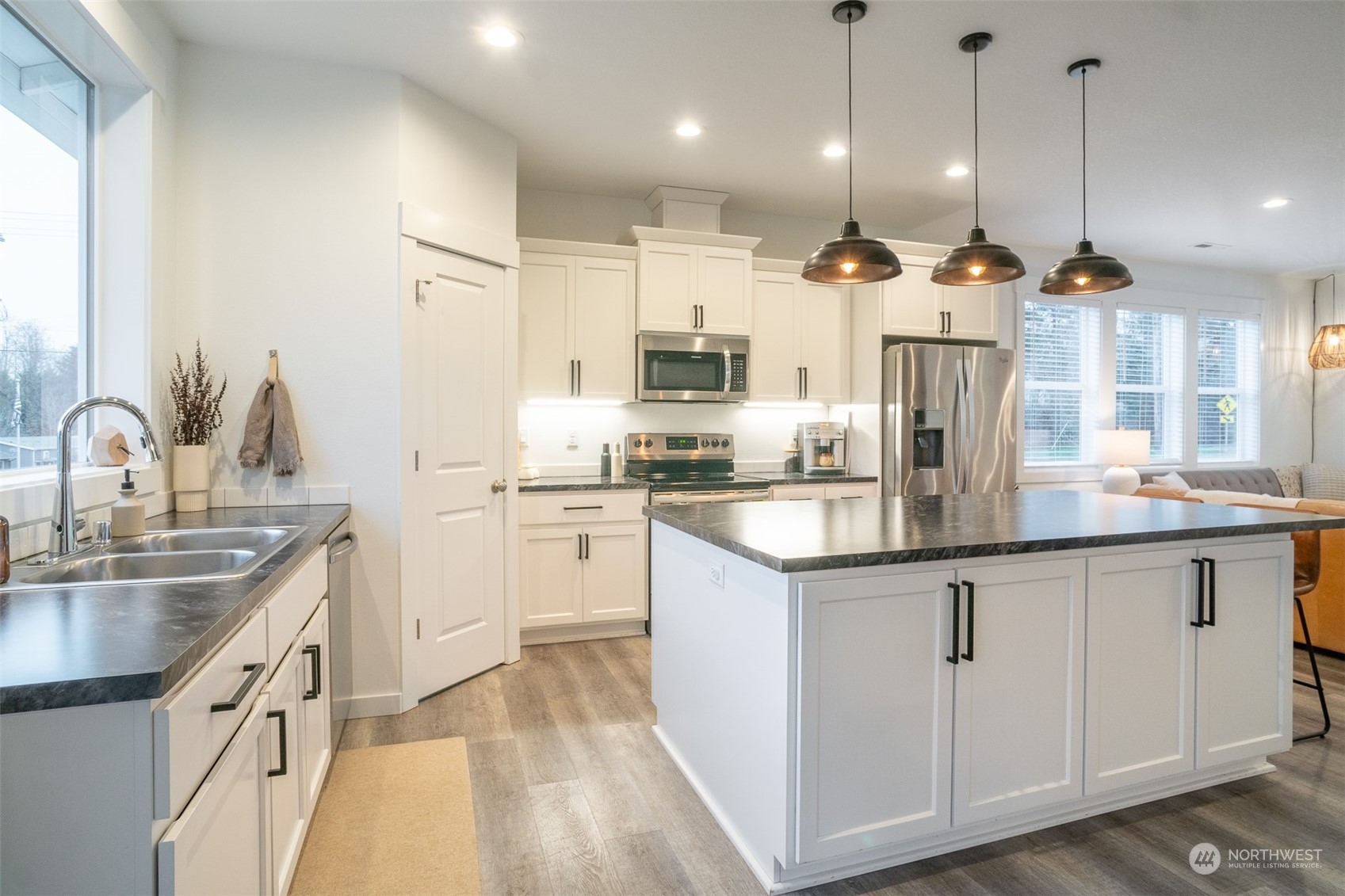 703 D Street Vader, WA 98593 - Photo 21 of 39 a kitchen with stainless steel appliances granite countertop a sink a stove a refrigerator and island with wooden floor