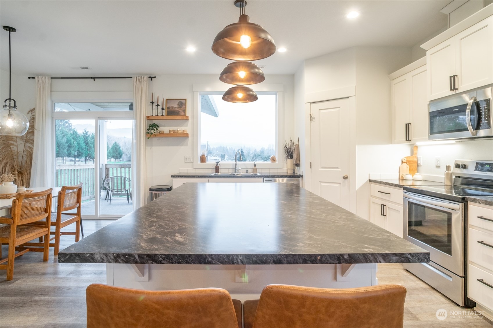 703 D Street Vader, WA 98593 - Photo 22 of 39 a kitchen with stainless steel appliances granite countertop a stove top oven a dining table and chairs