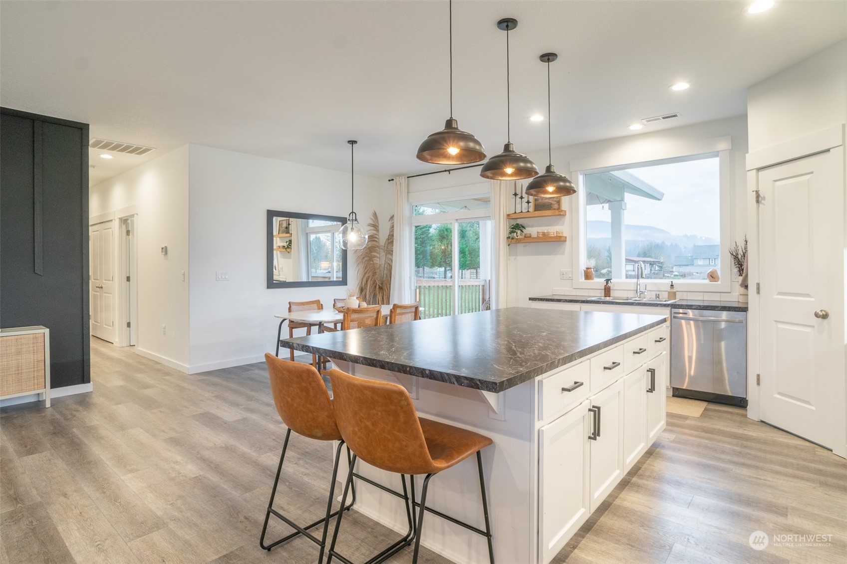 703 D Street Vader, WA 98593 - Photo 24 of 39 a kitchen with granite countertop a island a sink and a refrigerator