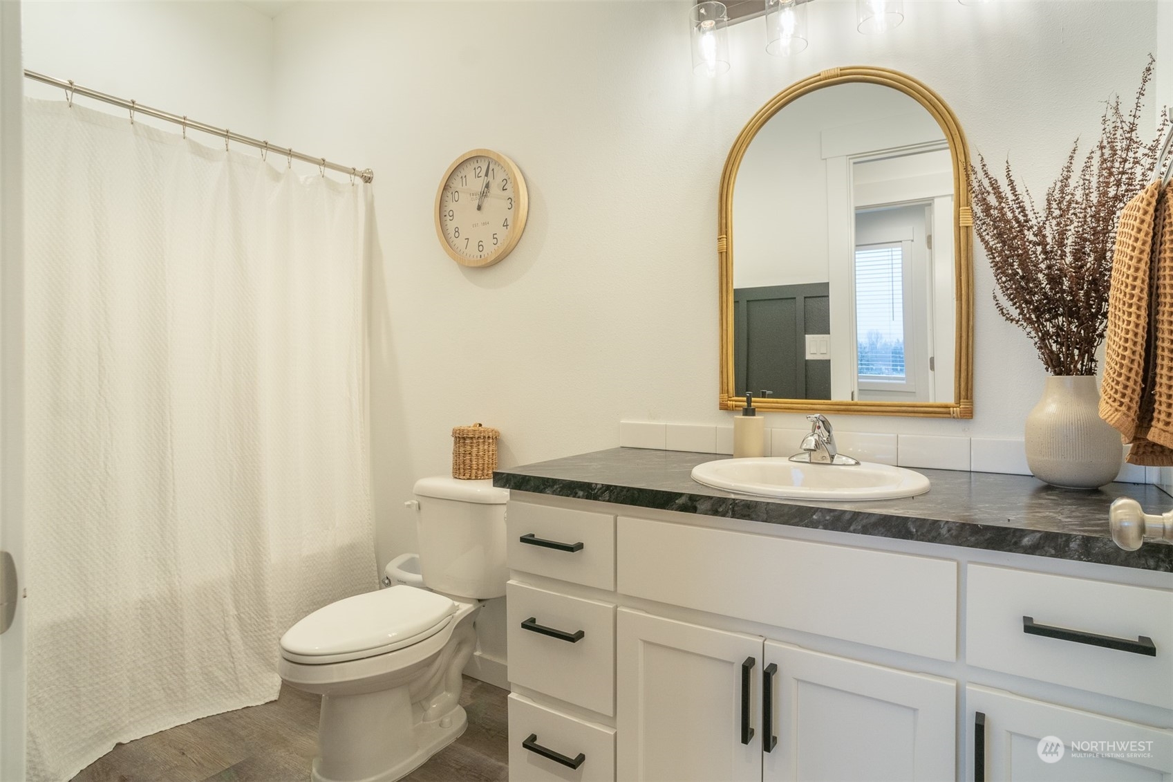 703 D Street Vader, WA 98593 - Photo 28 of 39 a bathroom with a granite countertop sink mirror vanity and toilet