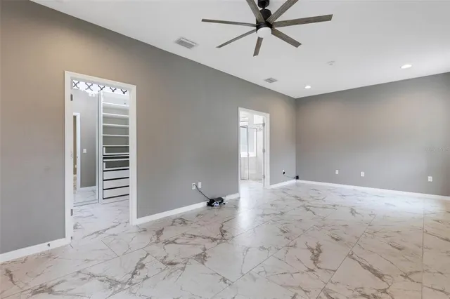 a bedroom with a large bed and a potted plant