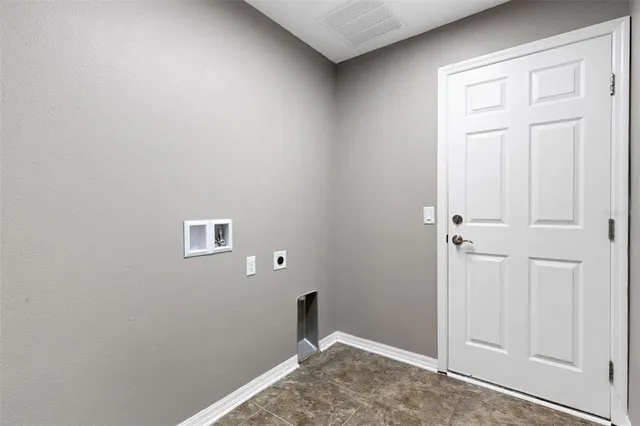 an aerial view of residential houses with outdoor space and ocean view