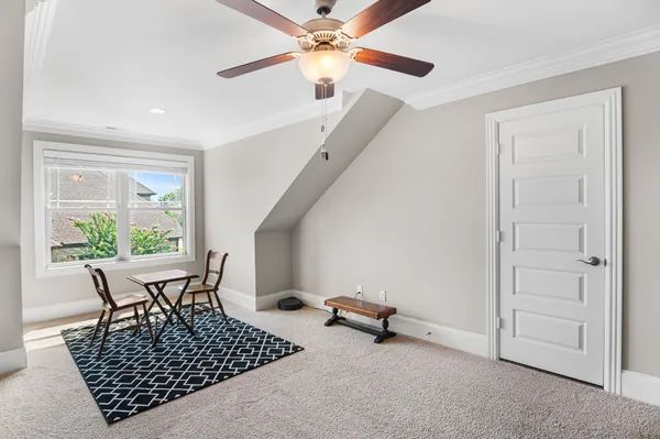 a dining room with furniture and a window