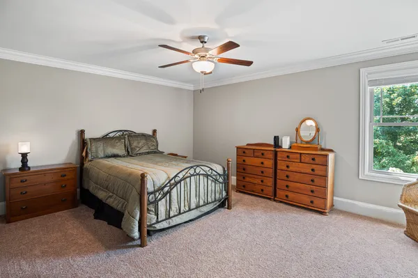 a bedroom with a bed and a chandelier