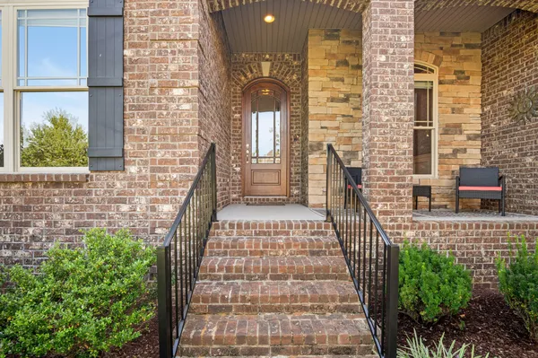 a view of a brick wall with an outdoor space
