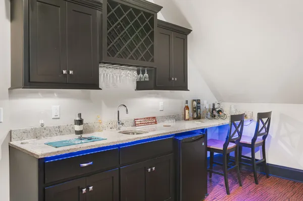 a kitchen with a sink cabinets and wooden floor
