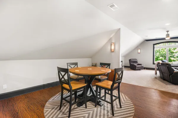 a view of a dining room with furniture and a wooden floor