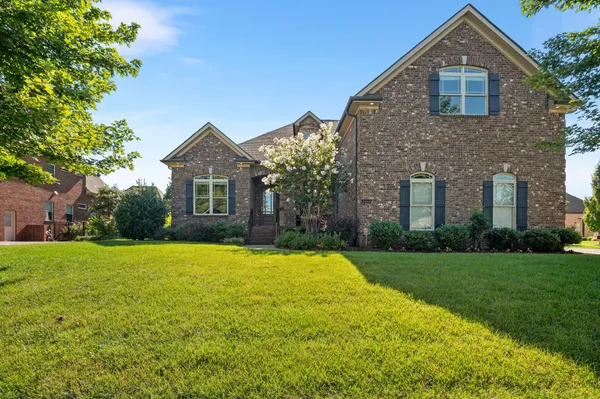 a front view of a house with a yard