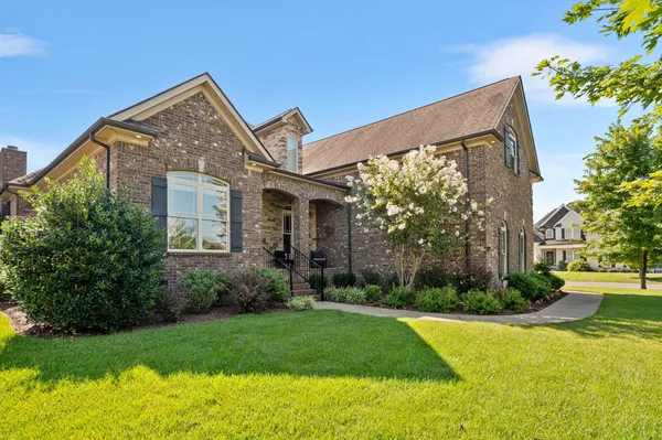 a front view of house with yard and green space