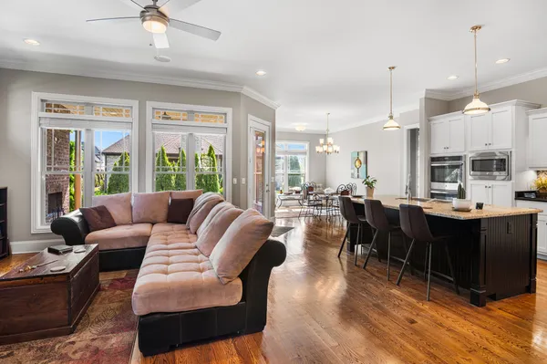 a living room with lots of furniture and a large window