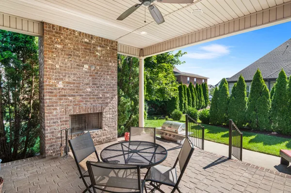 a patio with yard glass top table and chairs