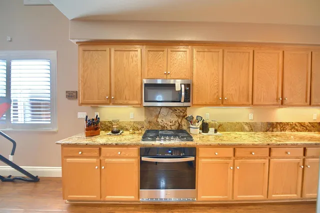 a bedroom with a bed a chandelier and a flat screen television