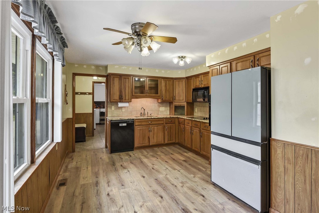 301 Crosse Road Amherst, OH 44001 - Photo 24 of 49 Kitchen featuring wood-finish flooring, ample cabinetry, a ceiling fan with integrated lighting, and multiple windows