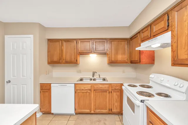 a kitchen with a sink a stove and cabinets