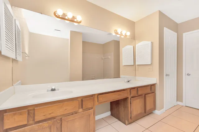 a bathroom with a sink double vanity and a mirror