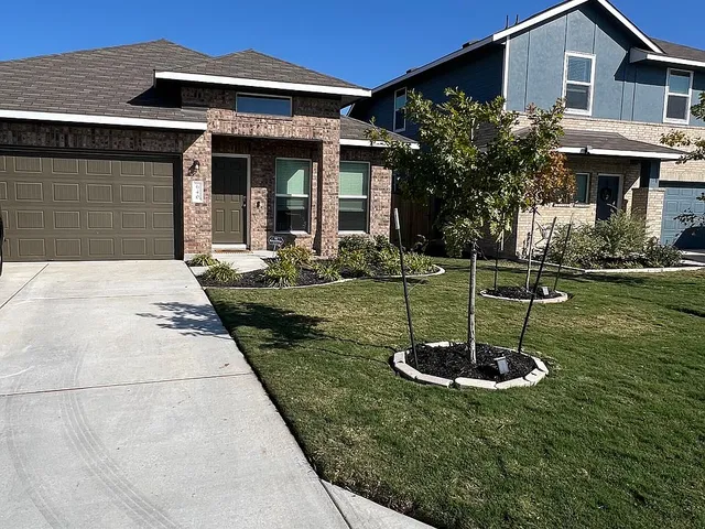 a front view of a house with garden