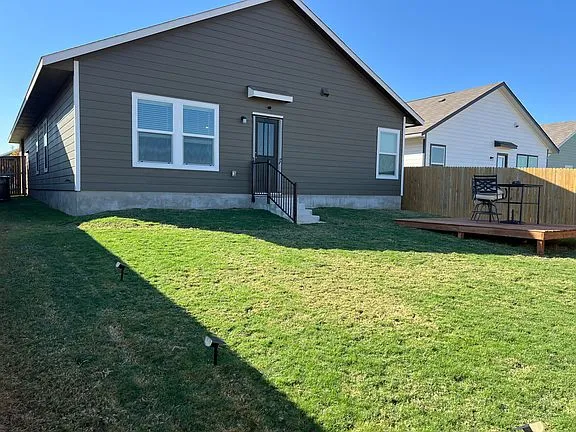 a view of a house with a yard and sitting area