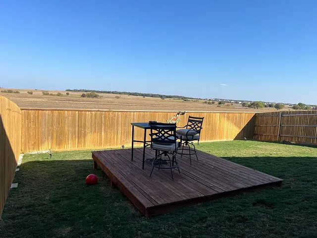 a view of a chairs and table on the lake