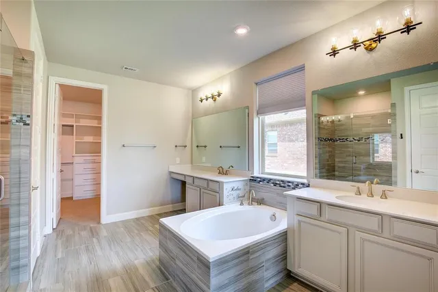 an empty room with windows and ceiling fan