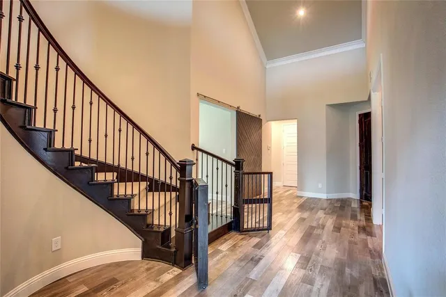 a view of staircase with wooden floor and a window