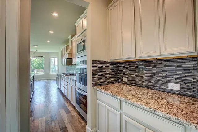 a kitchen with granite countertop a stove and a sink