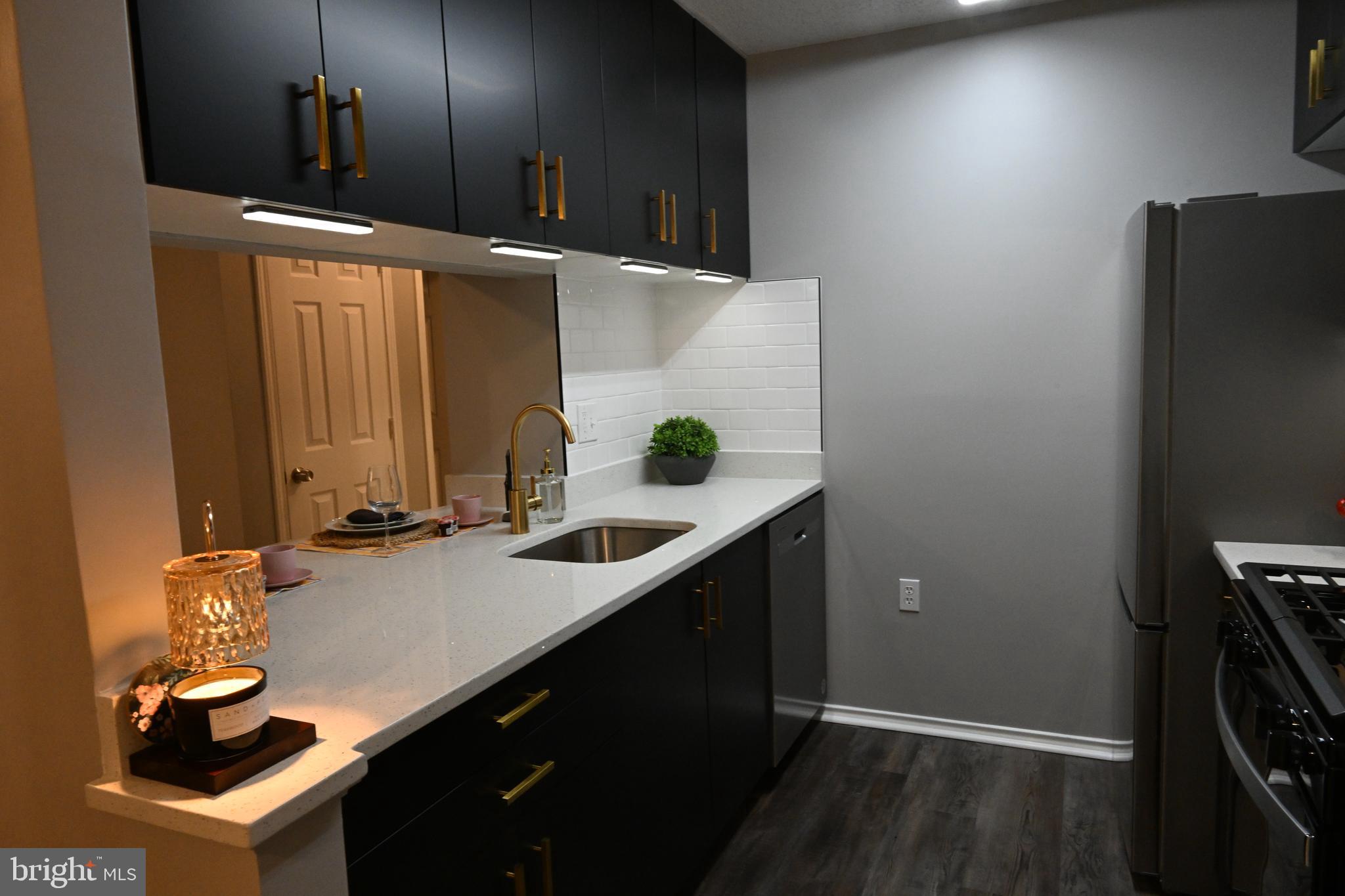 20965 Timber Ridge Terrace, Unit 304 Ashburn, VA 20147 - Photo 12 of 61 a bathroom with a sink and a mirror