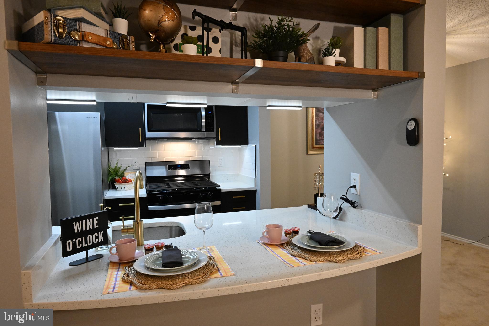 20965 Timber Ridge Terrace, Unit 304 Ashburn, VA 20147 - Photo 28 of 61 a kitchen with a sink and a stove top oven