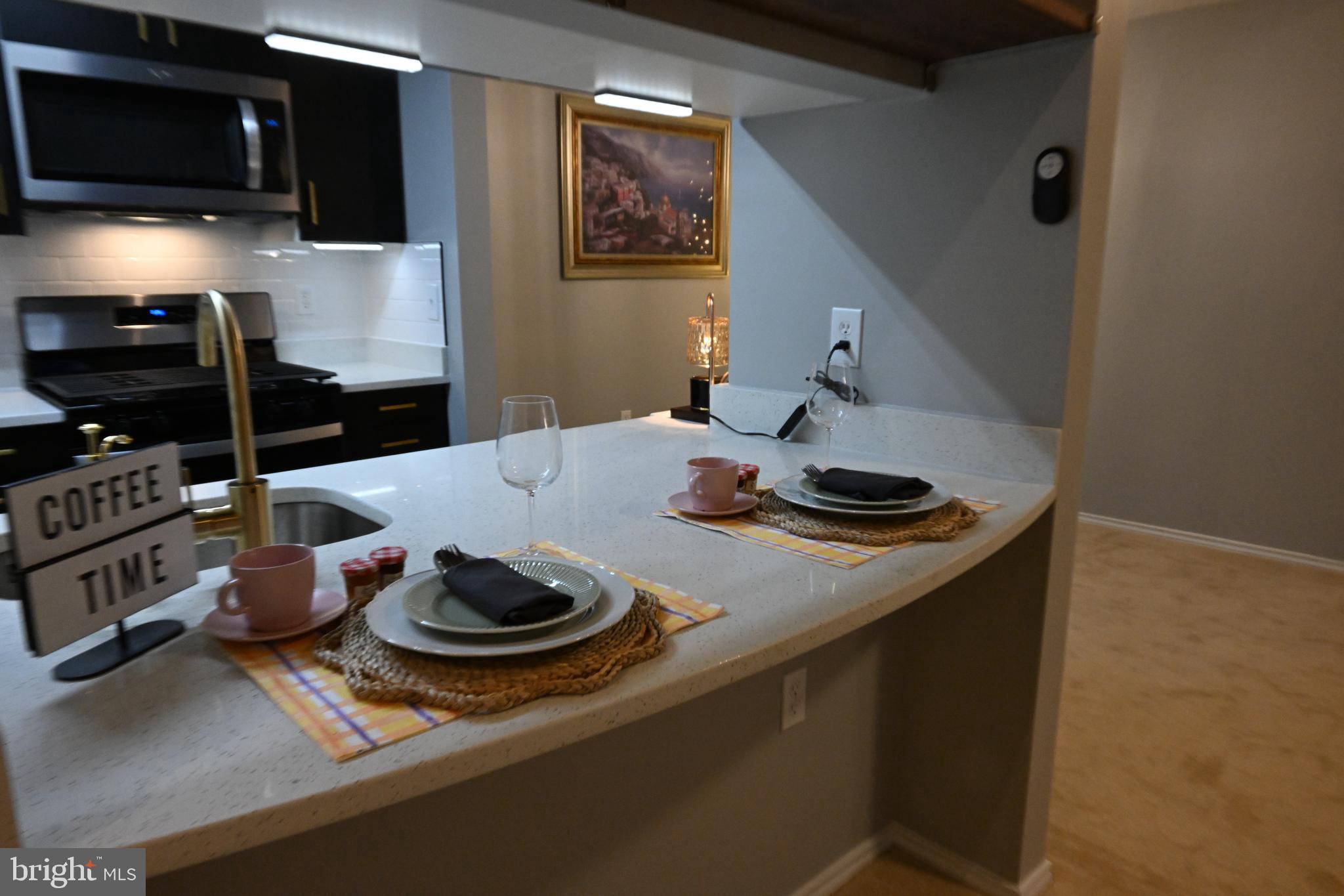 20965 Timber Ridge Terrace, Unit 304 Ashburn, VA 20147 - Photo 29 of 61 a kitchen with stainless steel appliances a sink a stove and a refrigerator