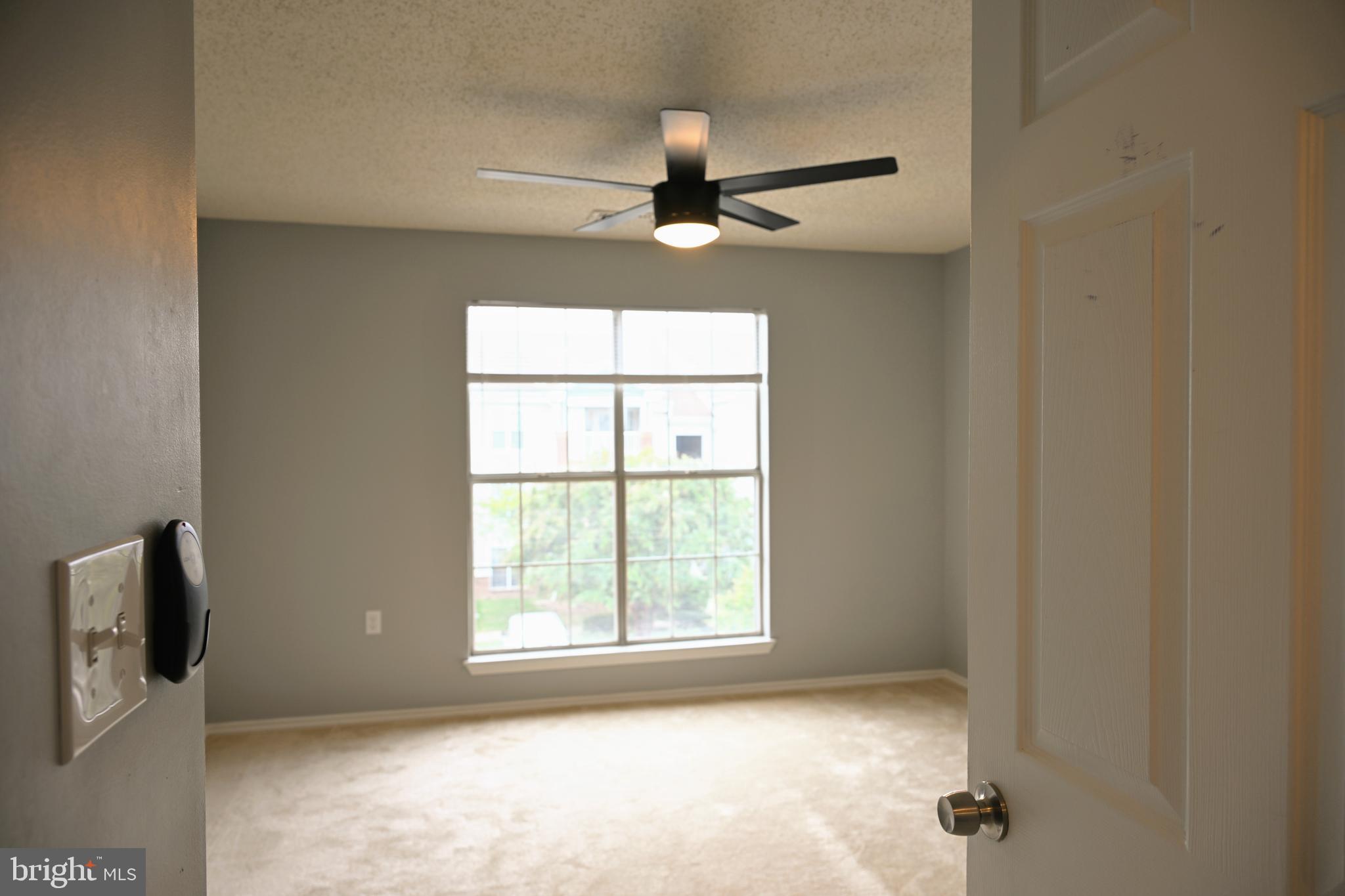 20965 Timber Ridge Terrace, Unit 304 Ashburn, VA 20147 - Photo 38 of 61 an empty room with windows and fan