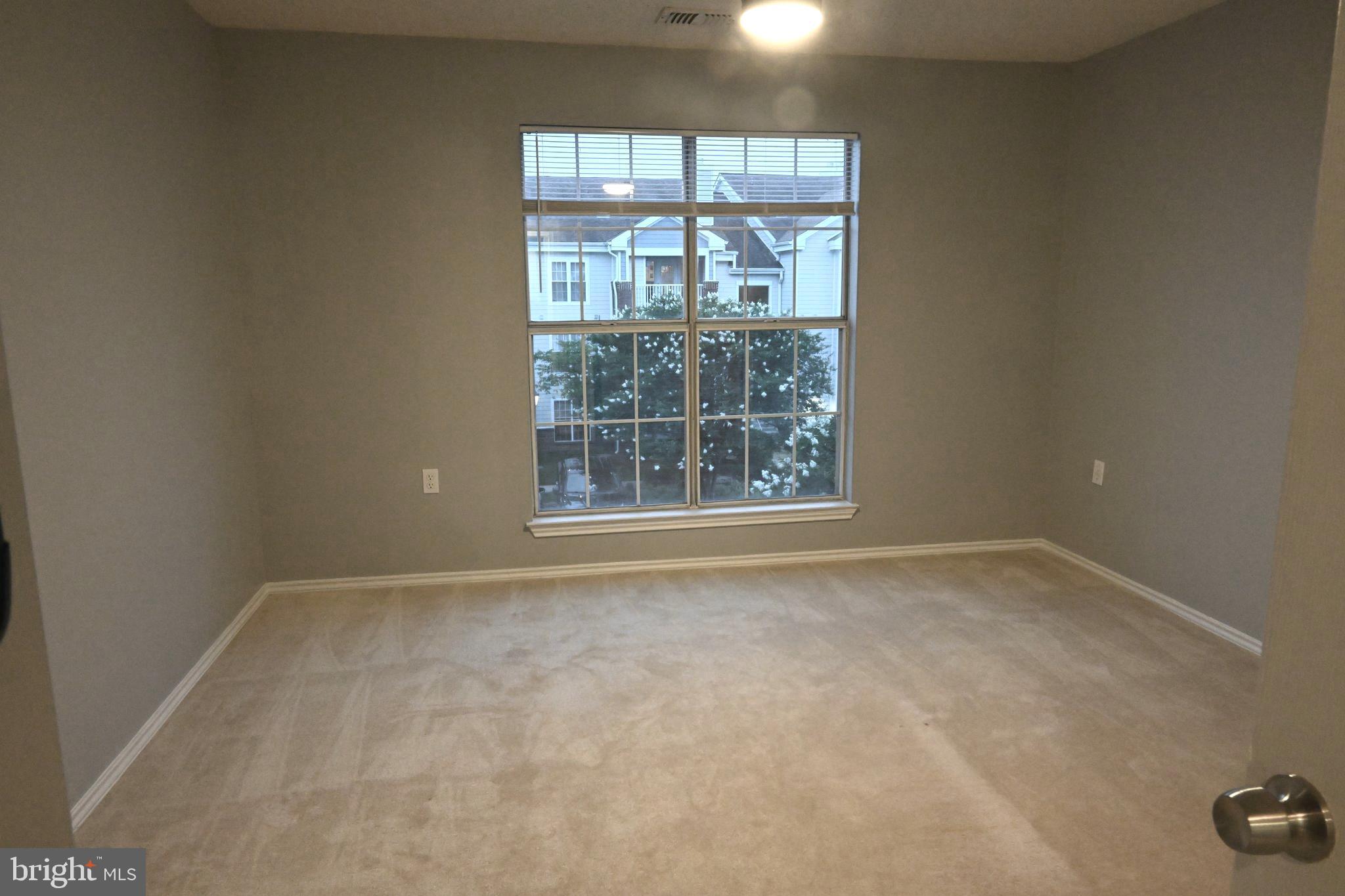 20965 Timber Ridge Terrace, Unit 304 Ashburn, VA 20147 - Photo 39 of 61 an empty room with a window