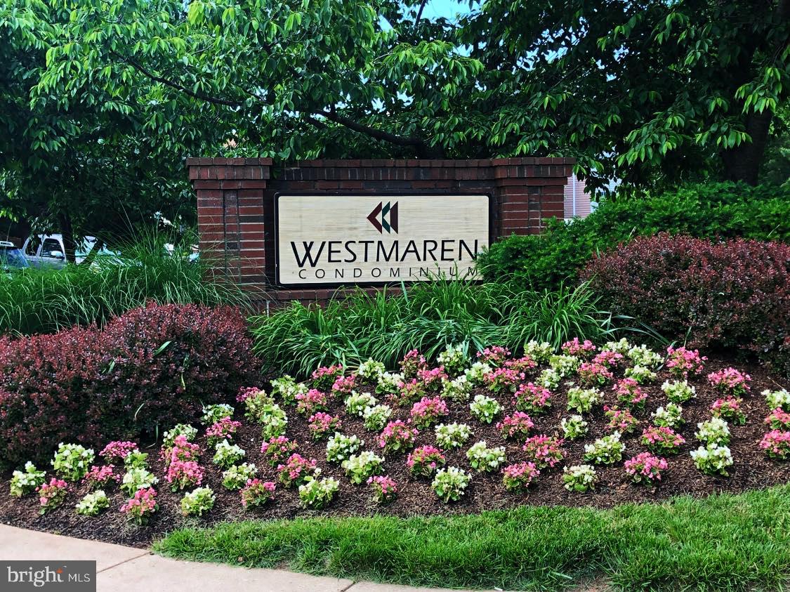 20965 Timber Ridge Terrace, Unit 304 Ashburn, VA 20147 - Photo 4 of 61 a view of sign board with plants in the background