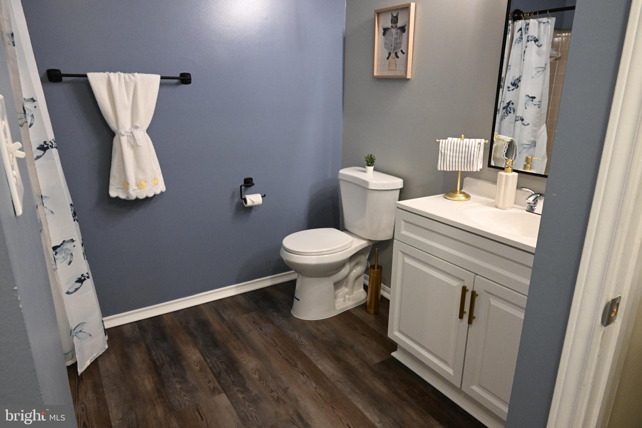 20965 Timber Ridge Terrace, Unit 304 Ashburn, VA 20147 - Photo 47 of 61 a white toilet sitting next to a white sink and vanity