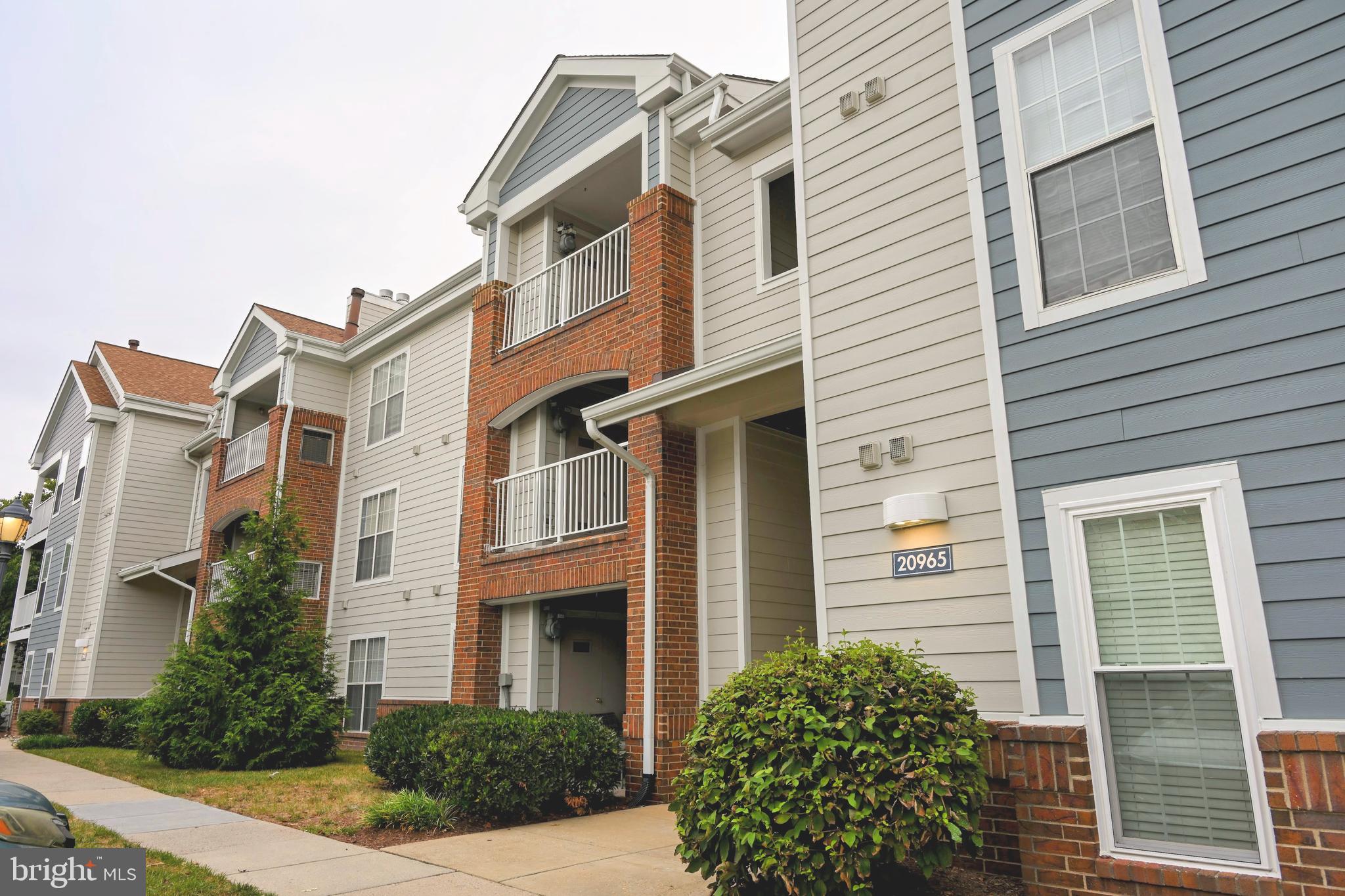 20965 Timber Ridge Terrace, Unit 304 Ashburn, VA 20147 - Photo 55 of 61 a view of a brick house with many windows