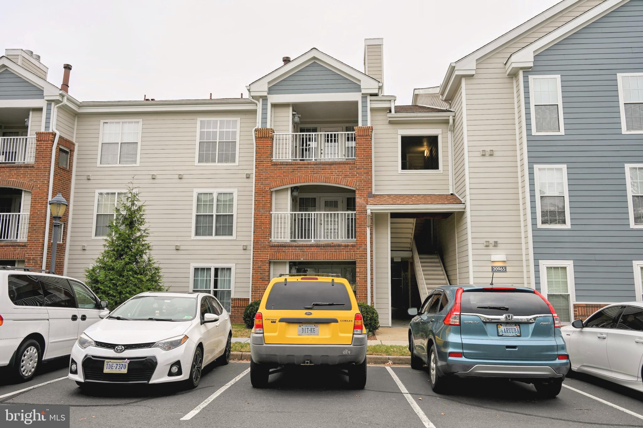 20965 Timber Ridge Terrace, Unit 304 Ashburn, VA 20147 - Photo 56 of 61 a view of a car parked in front of a house